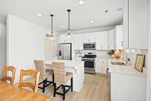 Modern kitchen with a central island featuring pendant lighting