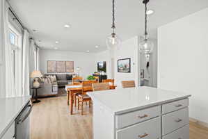 Kitchen island with a white countertop and brass hardware