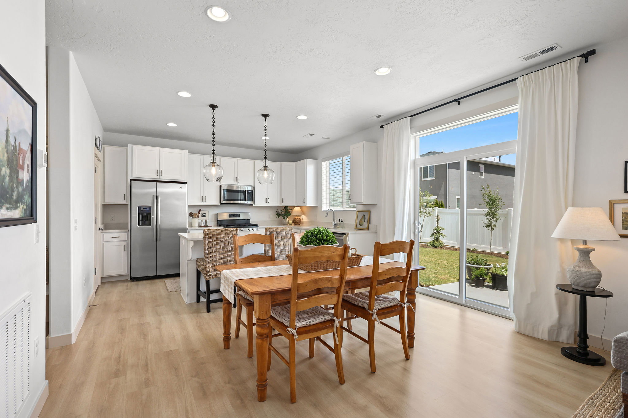 Open-concept space featuring wood-finish flooring, recessed lighting, and a modern kitchen