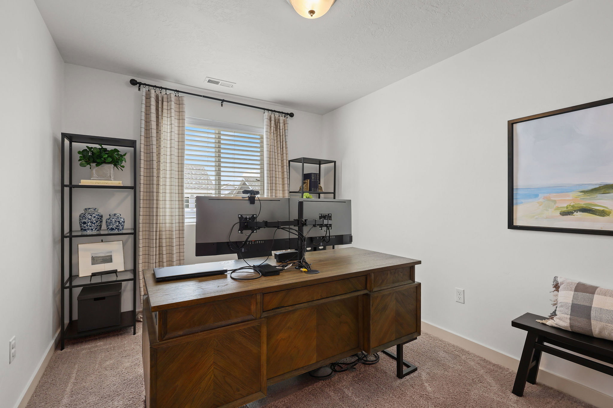 Neutral-toned room featuring a window with blinds and drapes, light-colored walls, and carpet flooring
