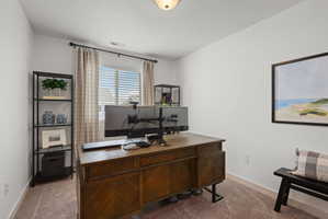 Neutral-toned room featuring a window with blinds and drapes, light-colored walls, and carpet flooring
