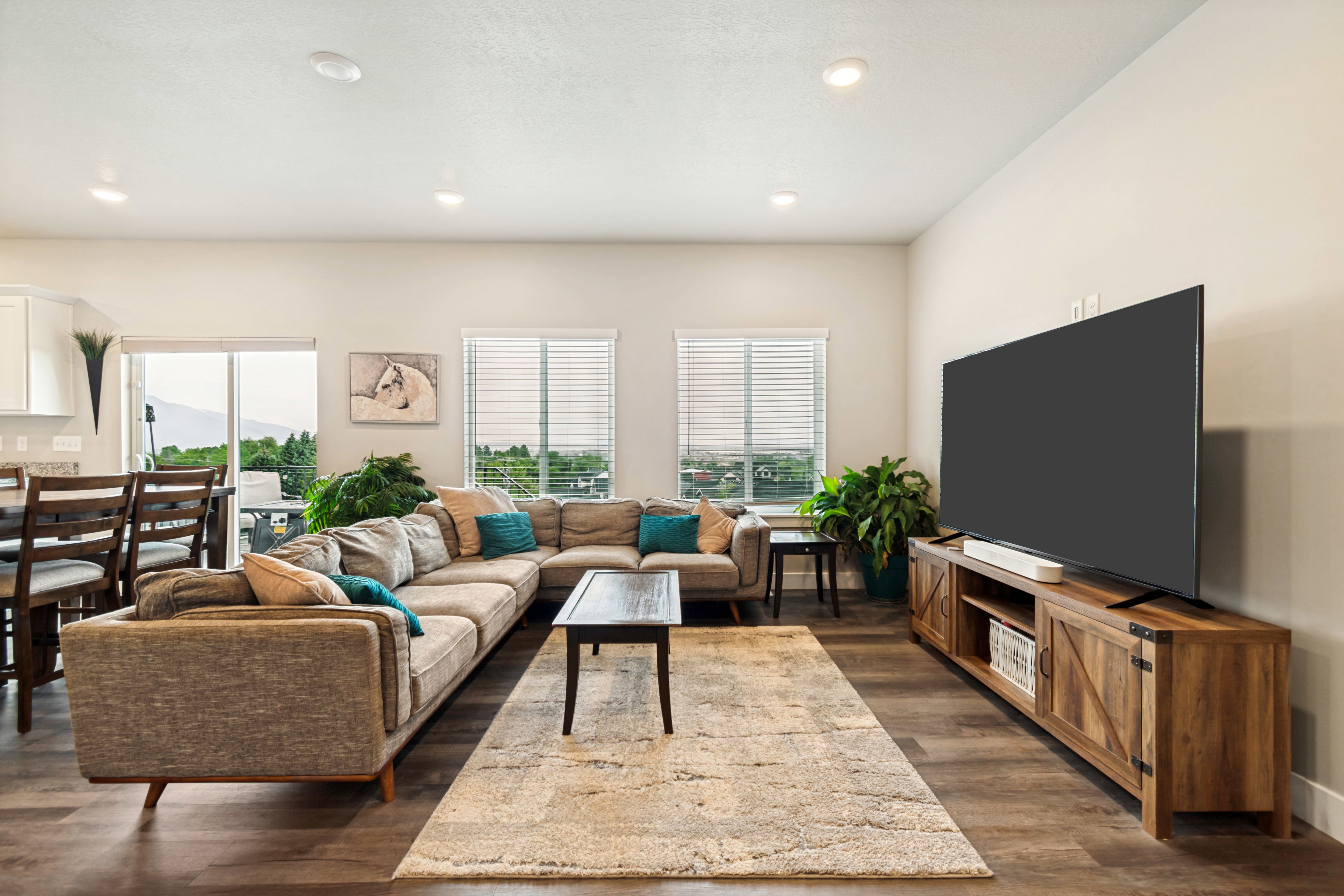 Spacious living area featuring wood-finish flooring, recessed lighting, and light-colored walls