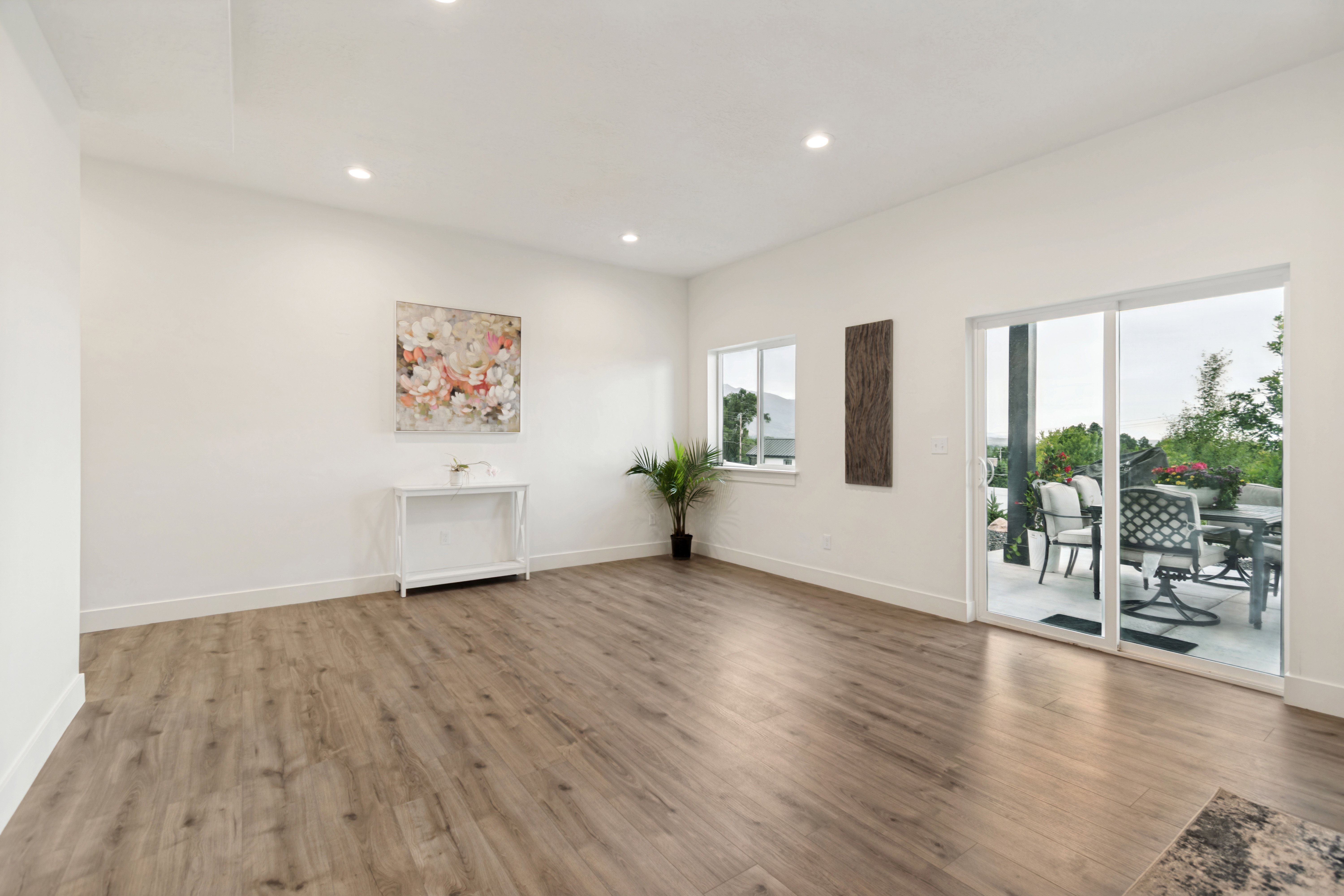 Spacious interior featuring wood-finish flooring, recessed lighting, and white baseboards