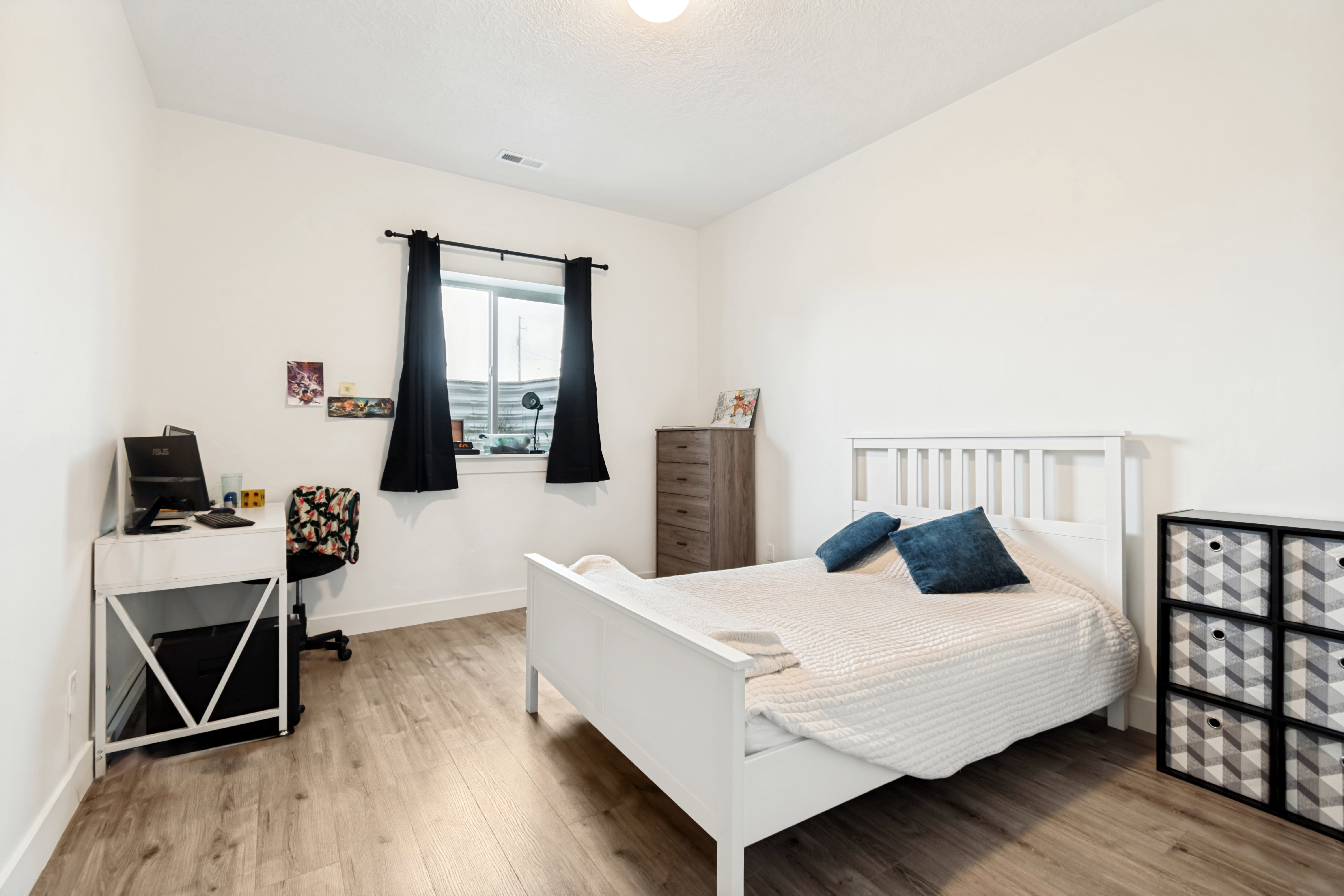 Bright room featuring light wood-finish flooring and white walls