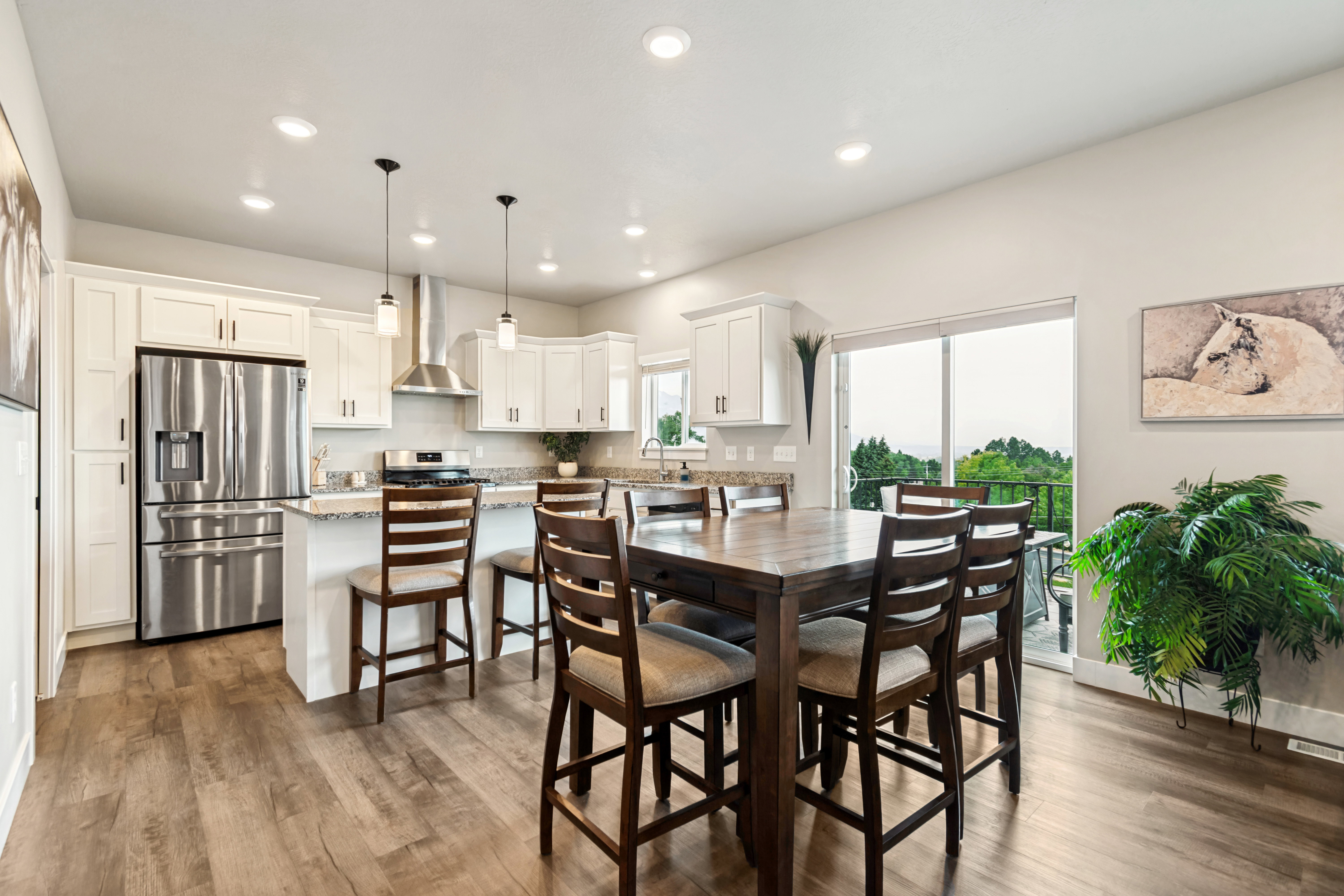 Open-concept kitchen and dining area featuring light-toned wood-finish flooring