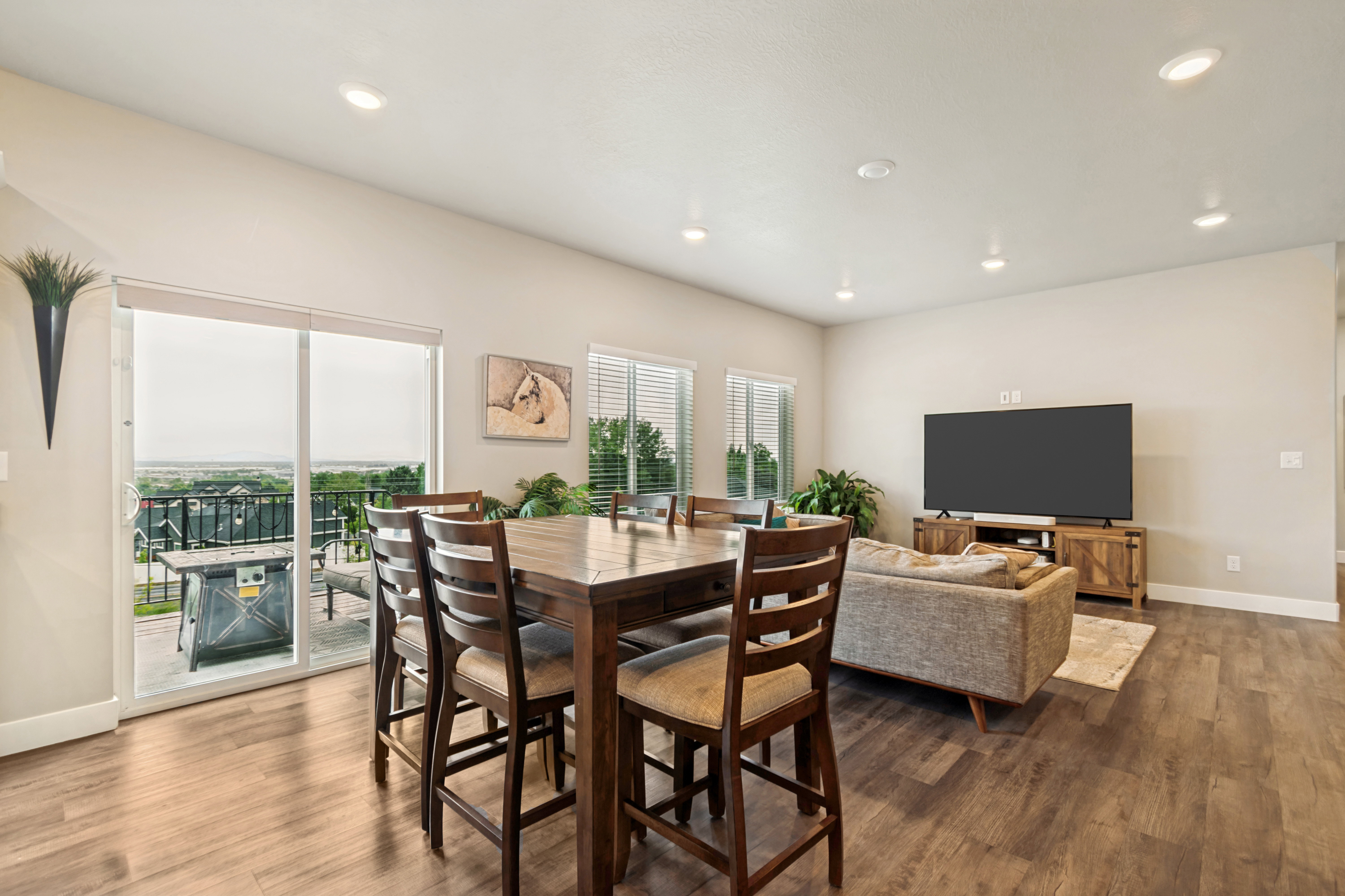 Open-concept living space featuring wood-finish flooring, recessed lighting, and light-toned walls