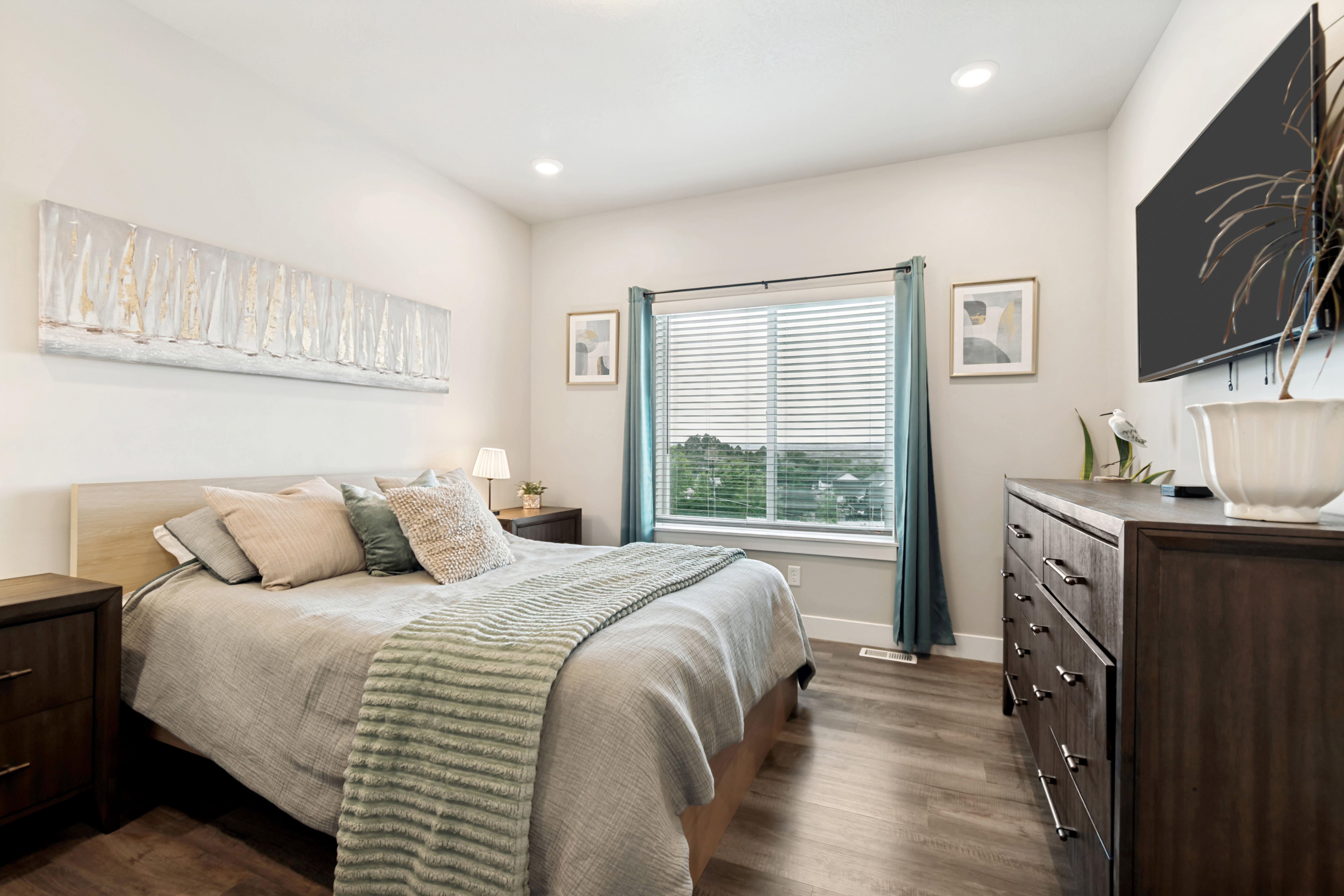 Spacious room featuring wood-finish flooring, recessed lighting, and a large window with horizontal blinds