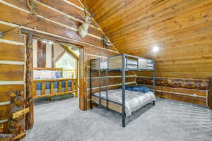 Natural wood-paneled walls and ceiling, featuring a bunk bed with metal frame construction