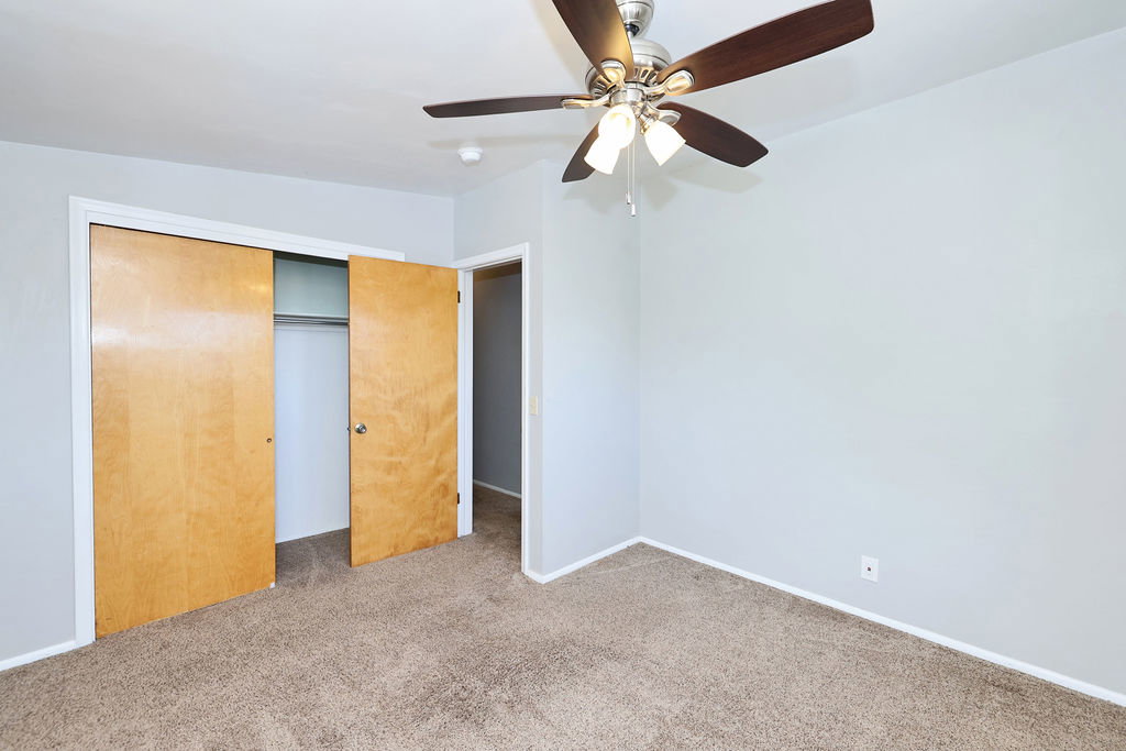 Neutral tone wall paint with a built-in ceiling fan and light fixture