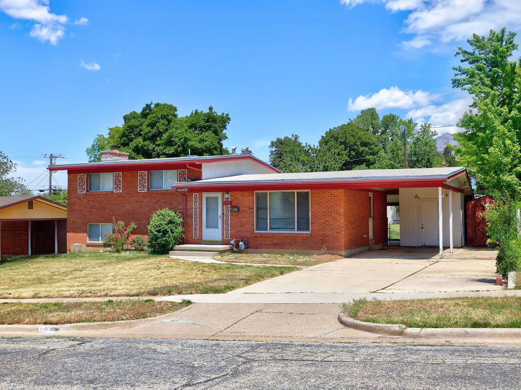Brick exterior with an integrated carport and a separate detached carport