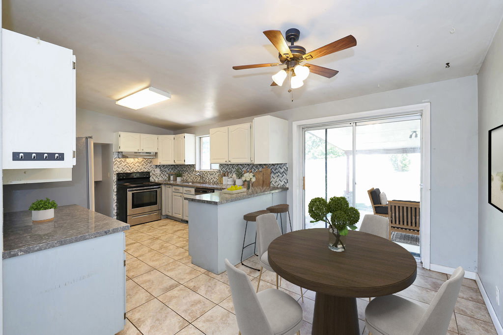 Kitchen with white cabinetry, stainless steel range, and tile backsplash