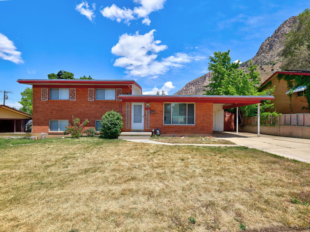 Brick exterior residence with a red-trimmed flat roofline
