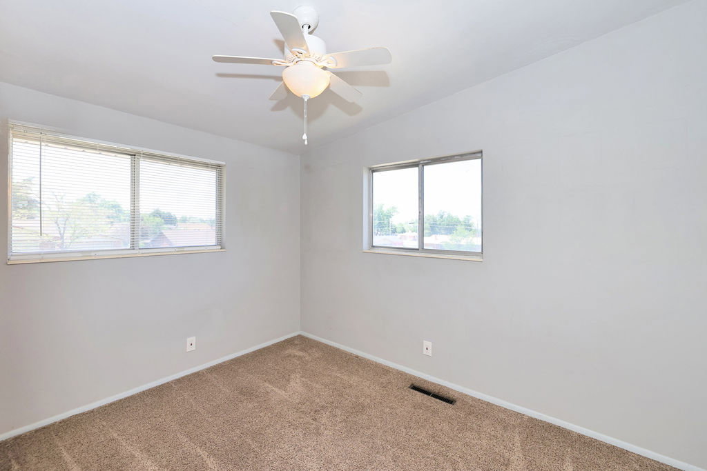 Neutral gray walls with light brown carpet flooring