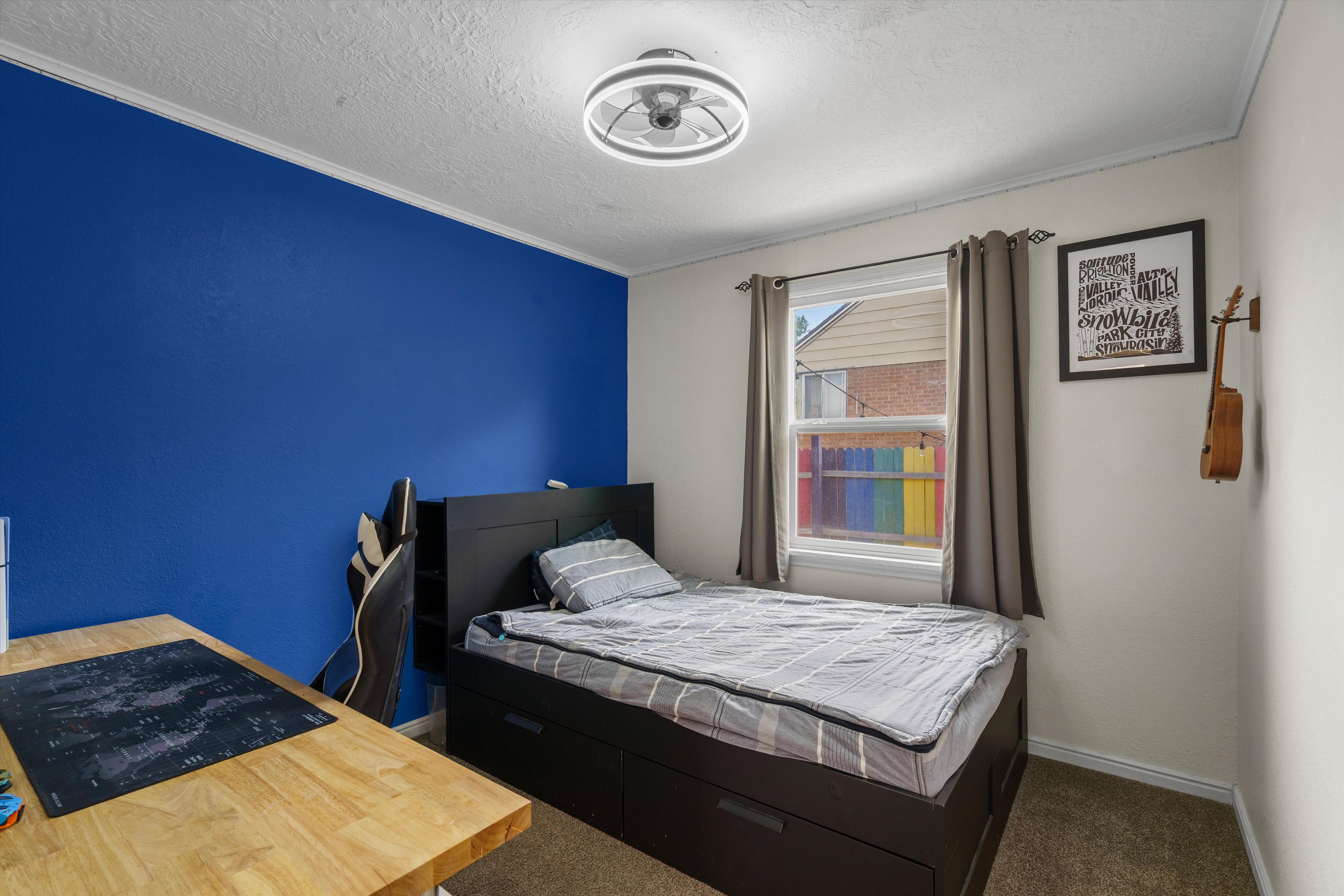Carpeted room with a single window, crown molding, and a modern ceiling light fixture