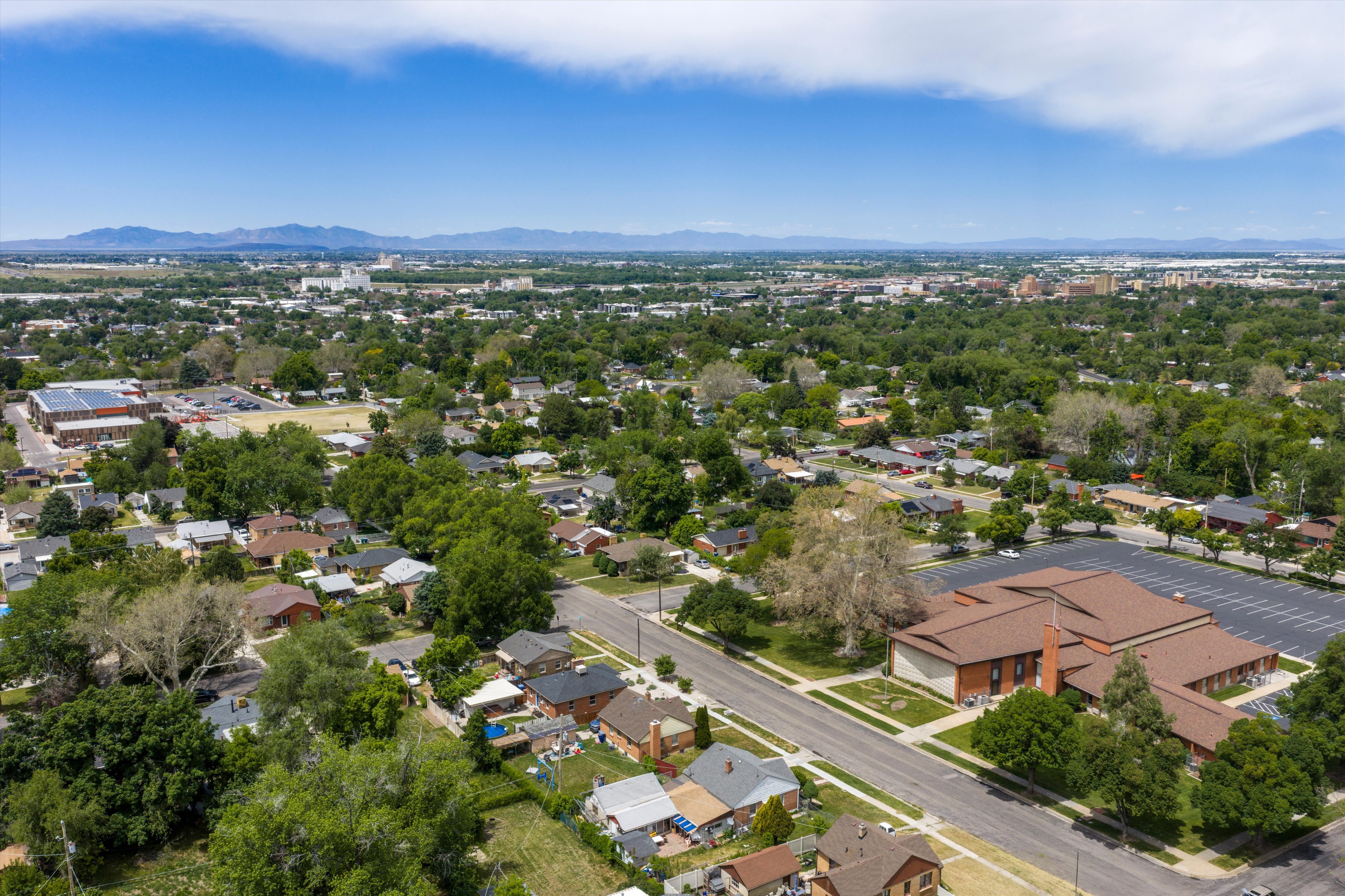 Aerial perspective showcasing a residential neighborhood with varied housing styles and mature tree cover
