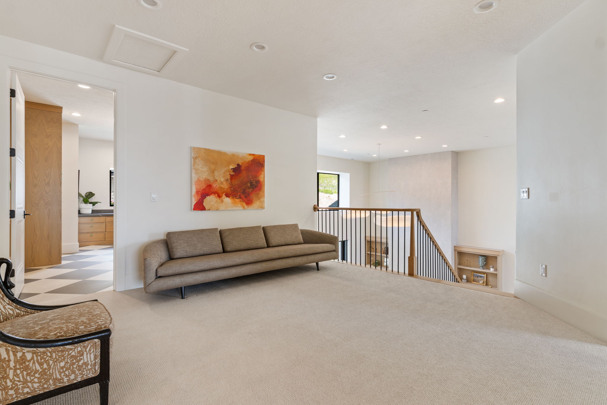 Carpeted upper level with recessed lighting and a white ceiling