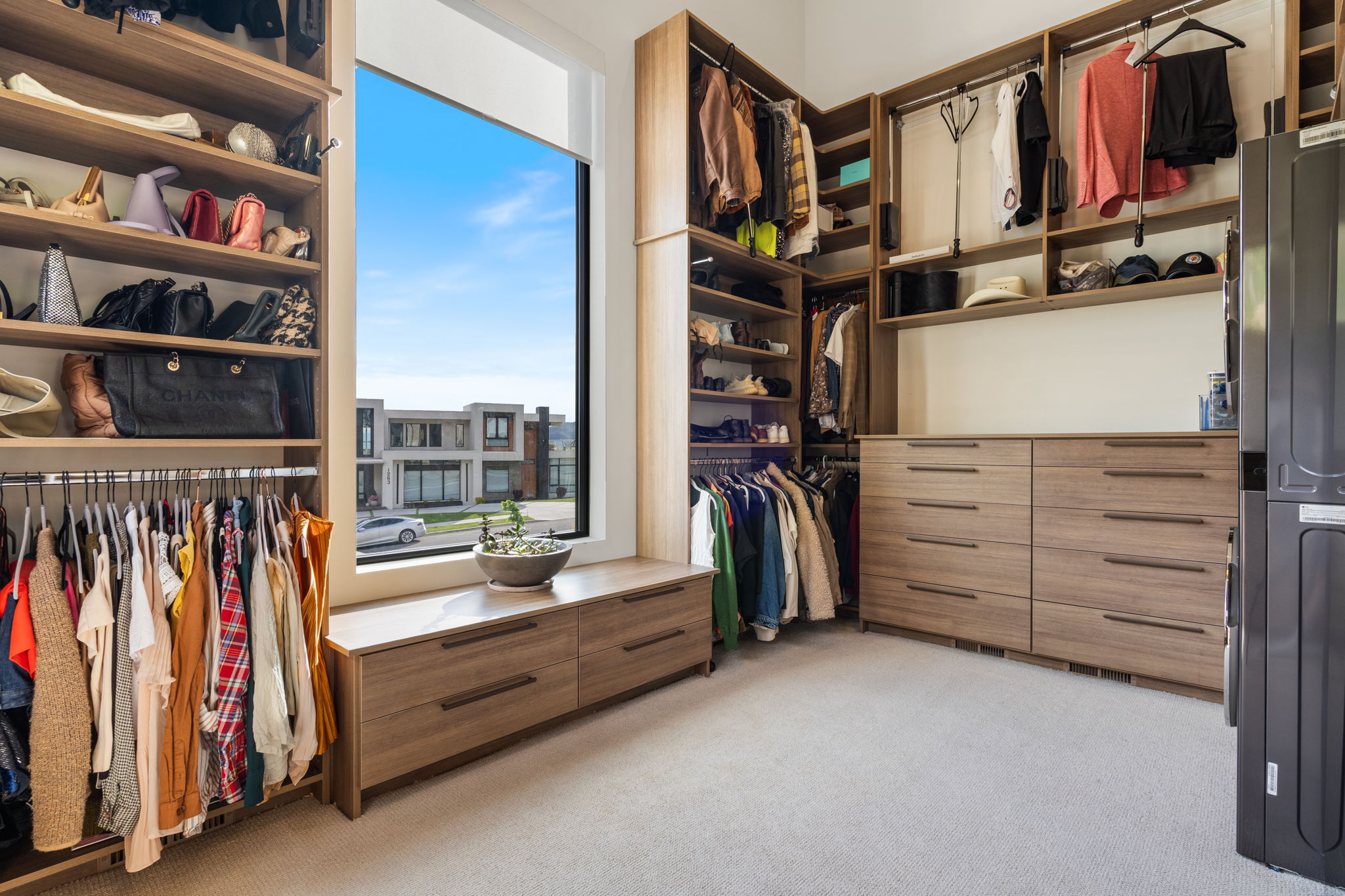 Custom closet system featuring extensive shelving, hanging rods, and built-in drawers