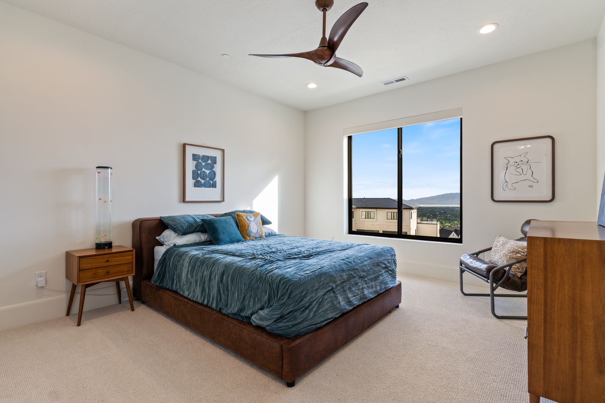 Expansive window framing distant mountains and houses