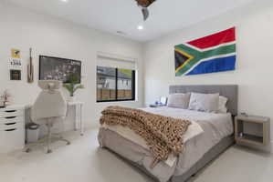 Carpeted bedroom with recessed lighting, a modern ceiling fan, and a large window featuring a roller shade