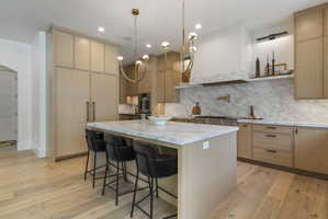 Contemporary kitchen featuring white oak cabinetry and engineered hardwood flooring