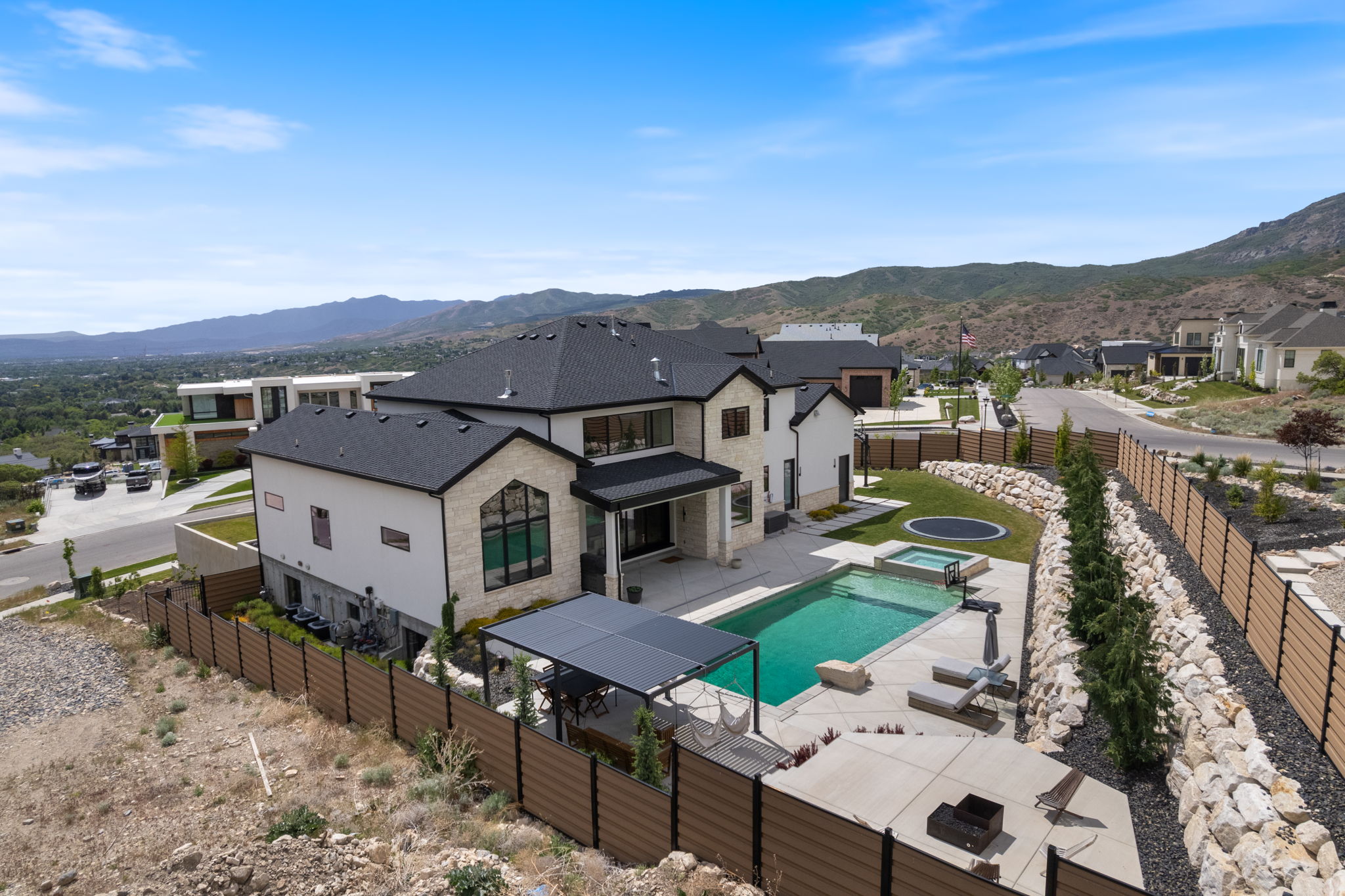 Contemporary residence featuring a multi-level design and a dark shingle roof