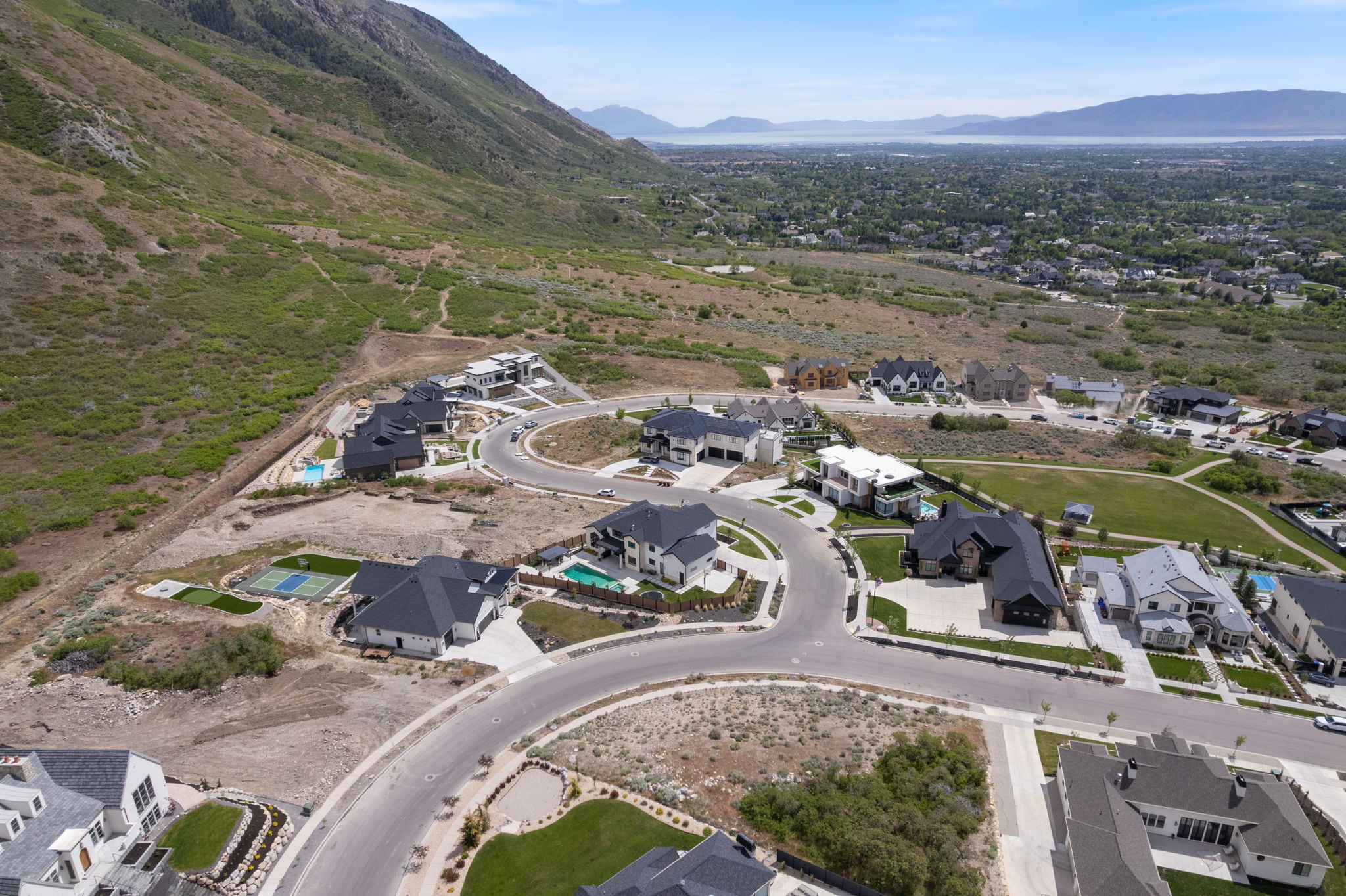 Aerial panorama showcasing a residential development with mountain and distant water features