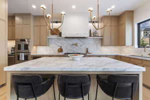 Expansive kitchen island featuring a marble countertop