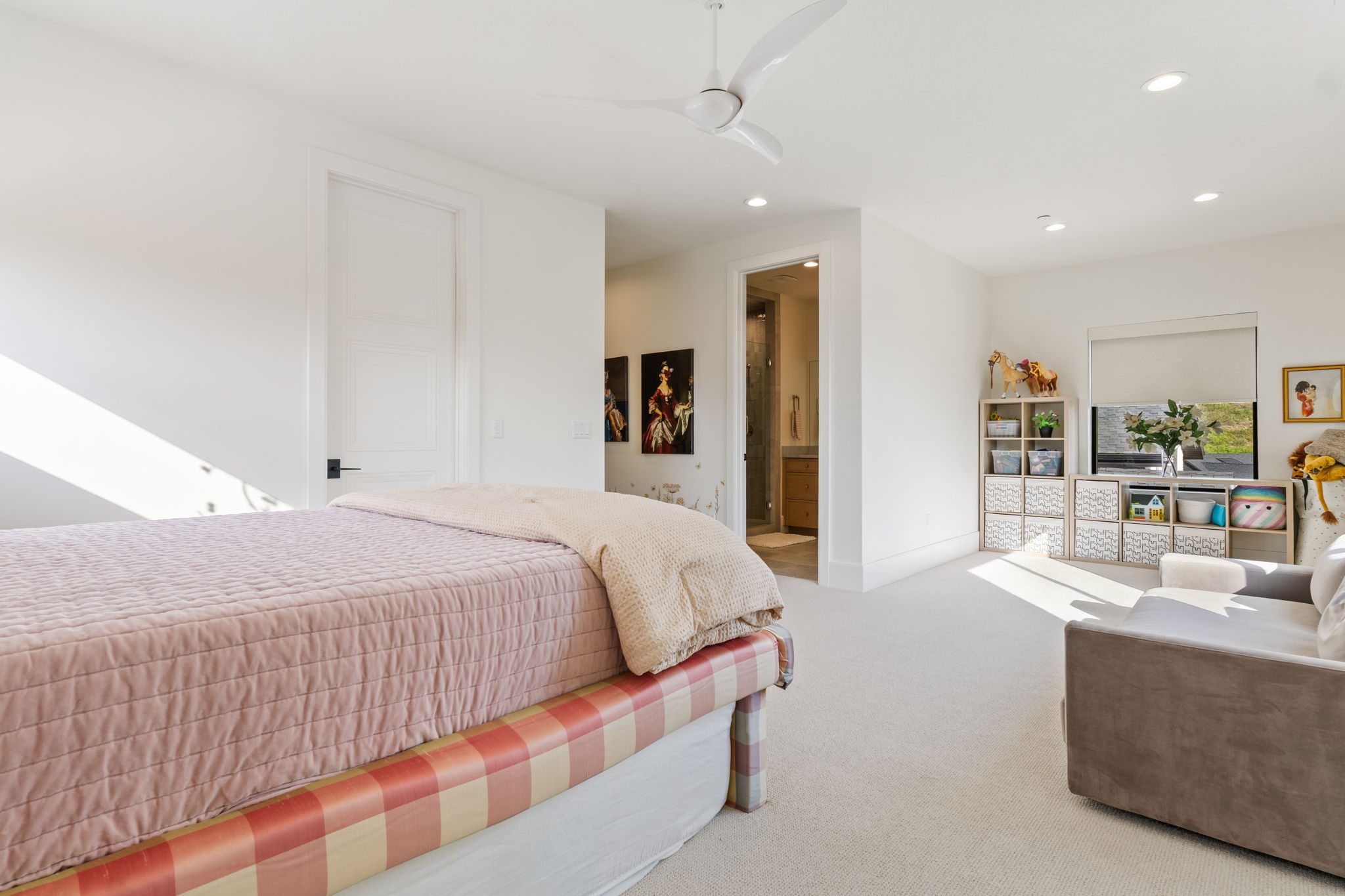 Spacious bedroom with light-colored carpet flooring and white walls