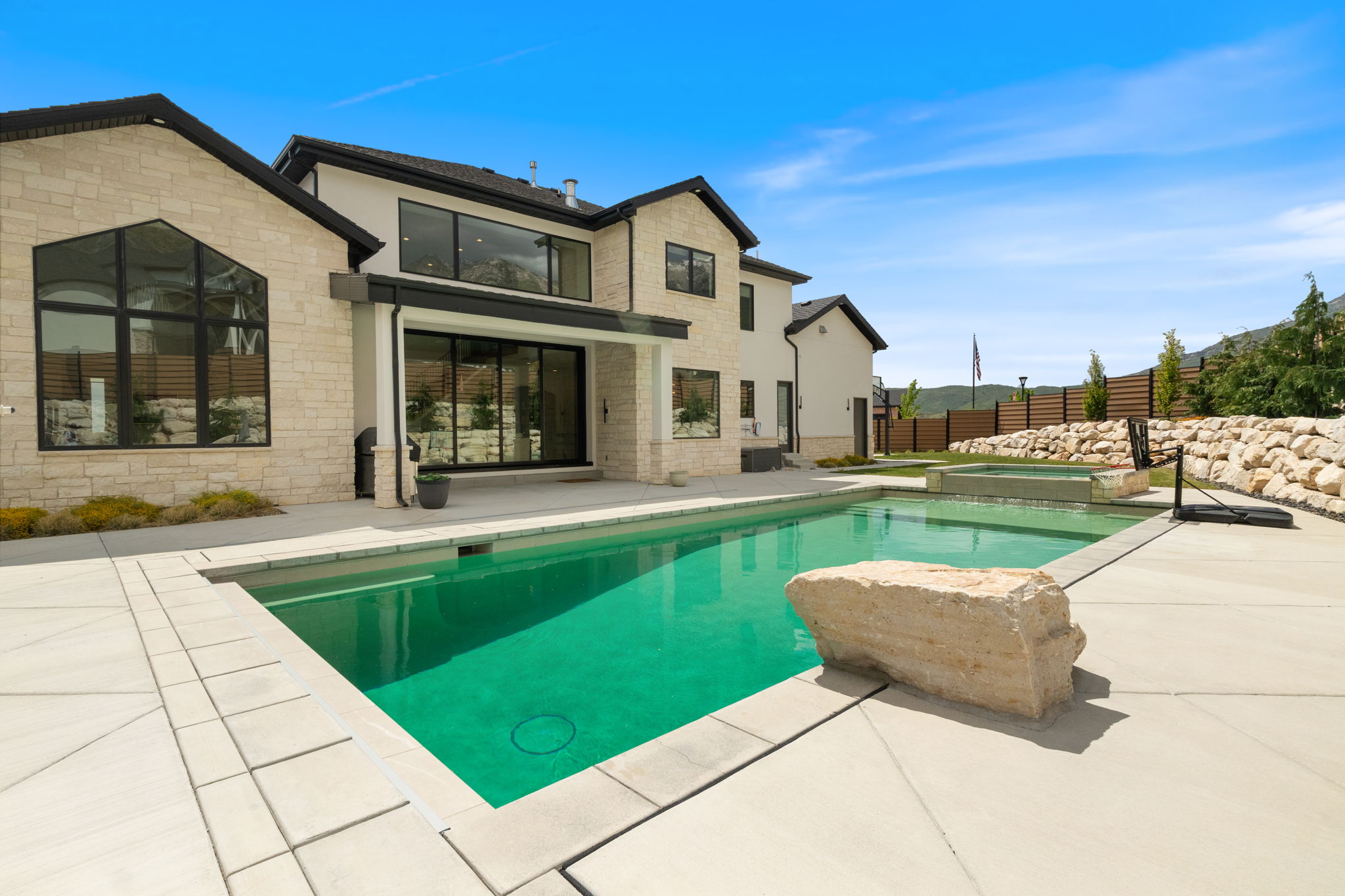 Contemporary residence featuring light-toned stone and stucco exterior