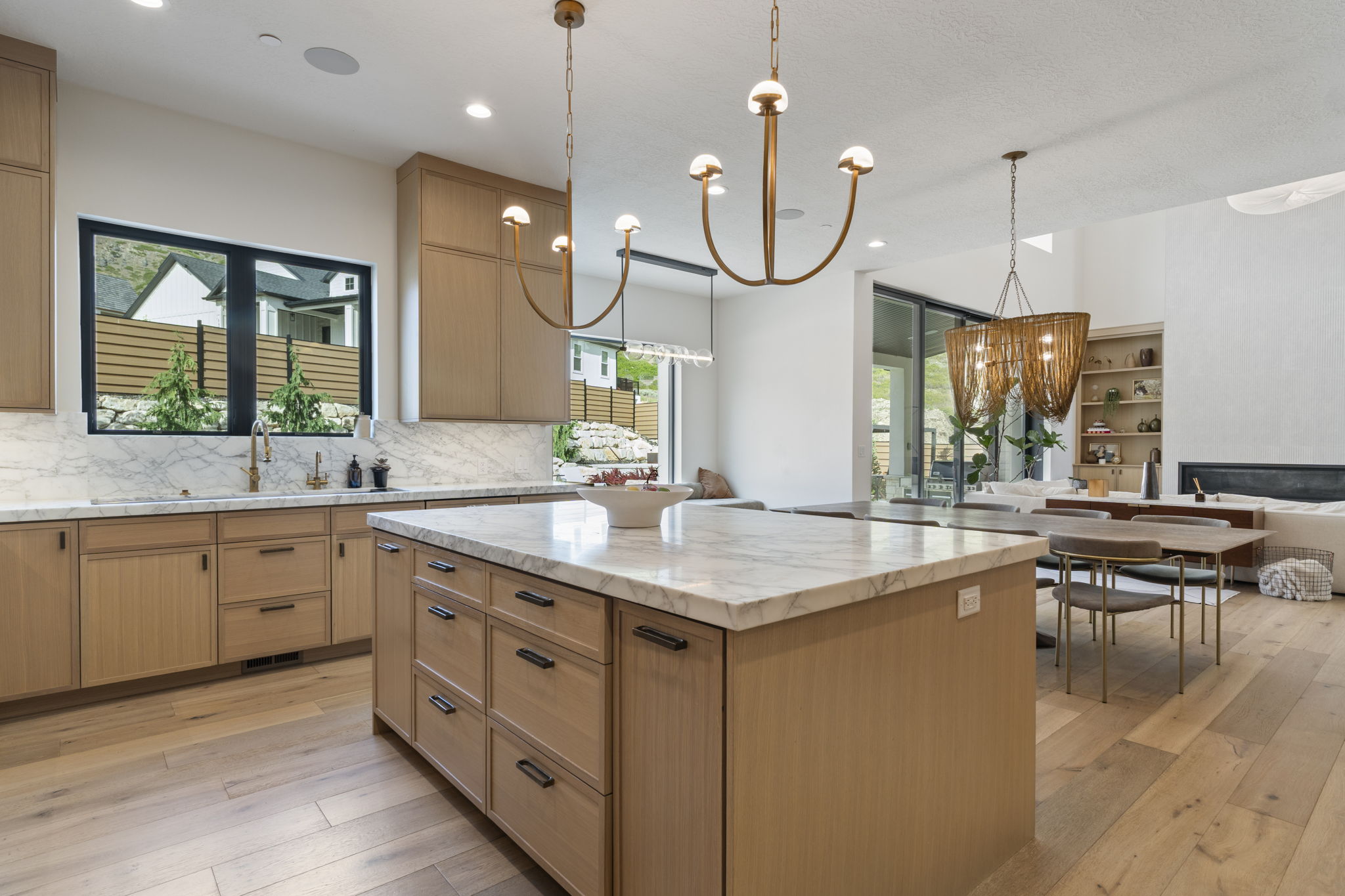 Kitchen island with a marble countertop and white oak cabinetry