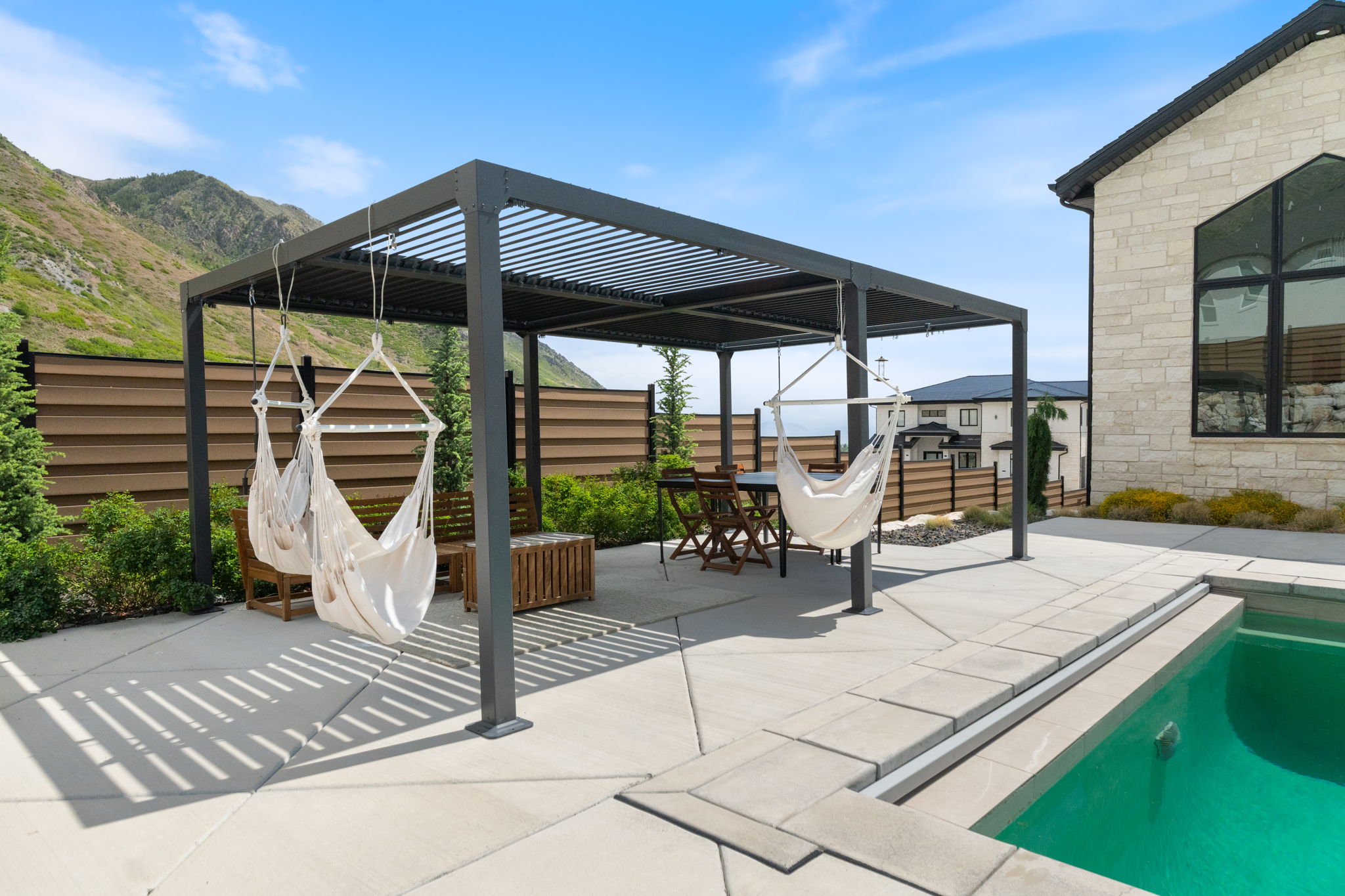 Expansive patio with a louvered pergola offering a dedicated outdoor living space
