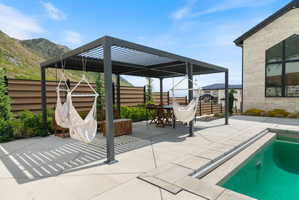 Expansive patio with a louvered pergola offering a dedicated outdoor living space