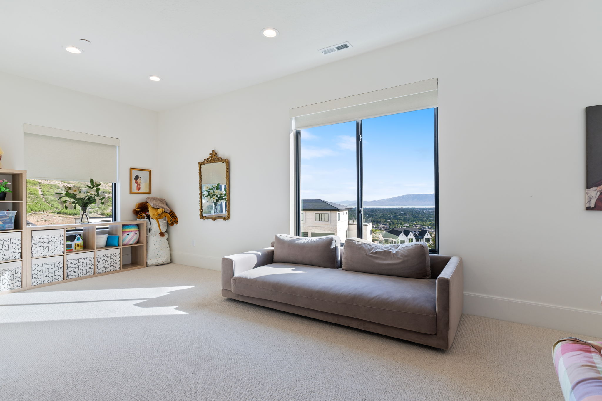 Spacious room with large windows, recessed lighting, and light-colored carpeting