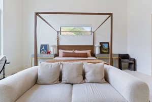 Spacious room featuring high ceilings and light-colored walls