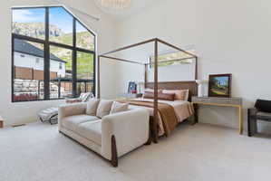 Expansive room featuring a vaulted ceiling and a large, multi-pane window framing a mountain backdrop