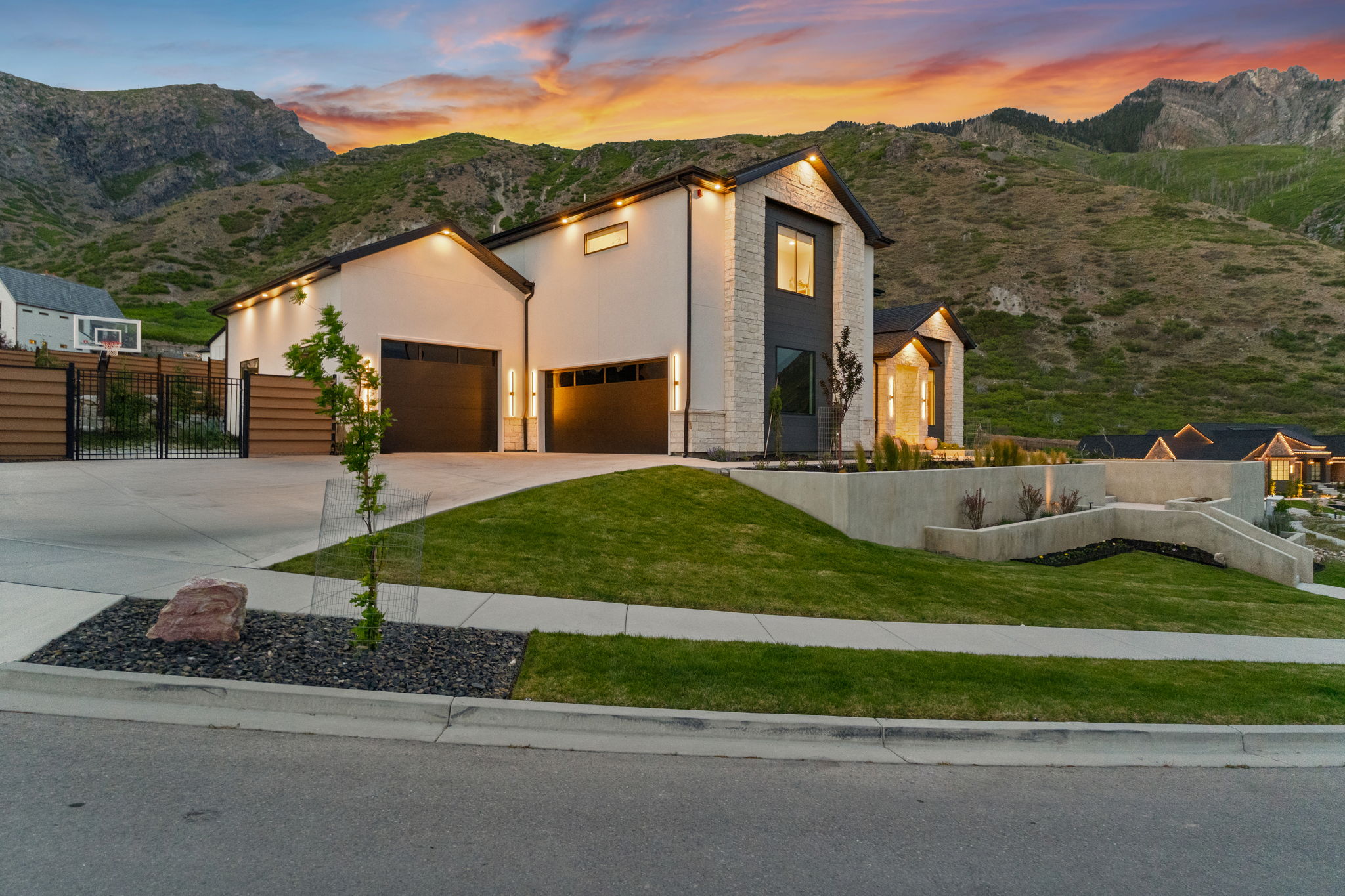 Modern architectural residence featuring a multi-tone facade with stone and stucco finishes