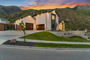 Modern architectural residence featuring a multi-tone facade with stone and stucco finishes