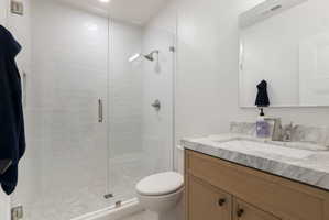 Walk-in shower with clear glass enclosure and tiled walls