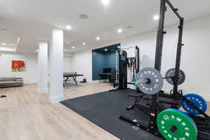 Dedicated fitness area featuring a power rack on a protective floor mat