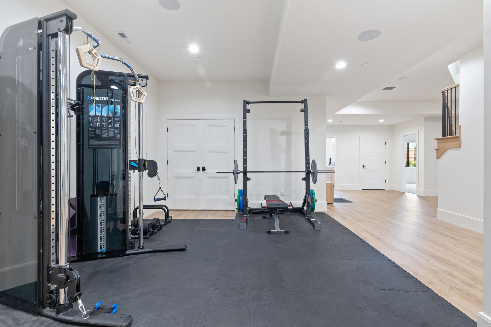 Dedicated exercise area featuring rubber floor matting and recessed lighting