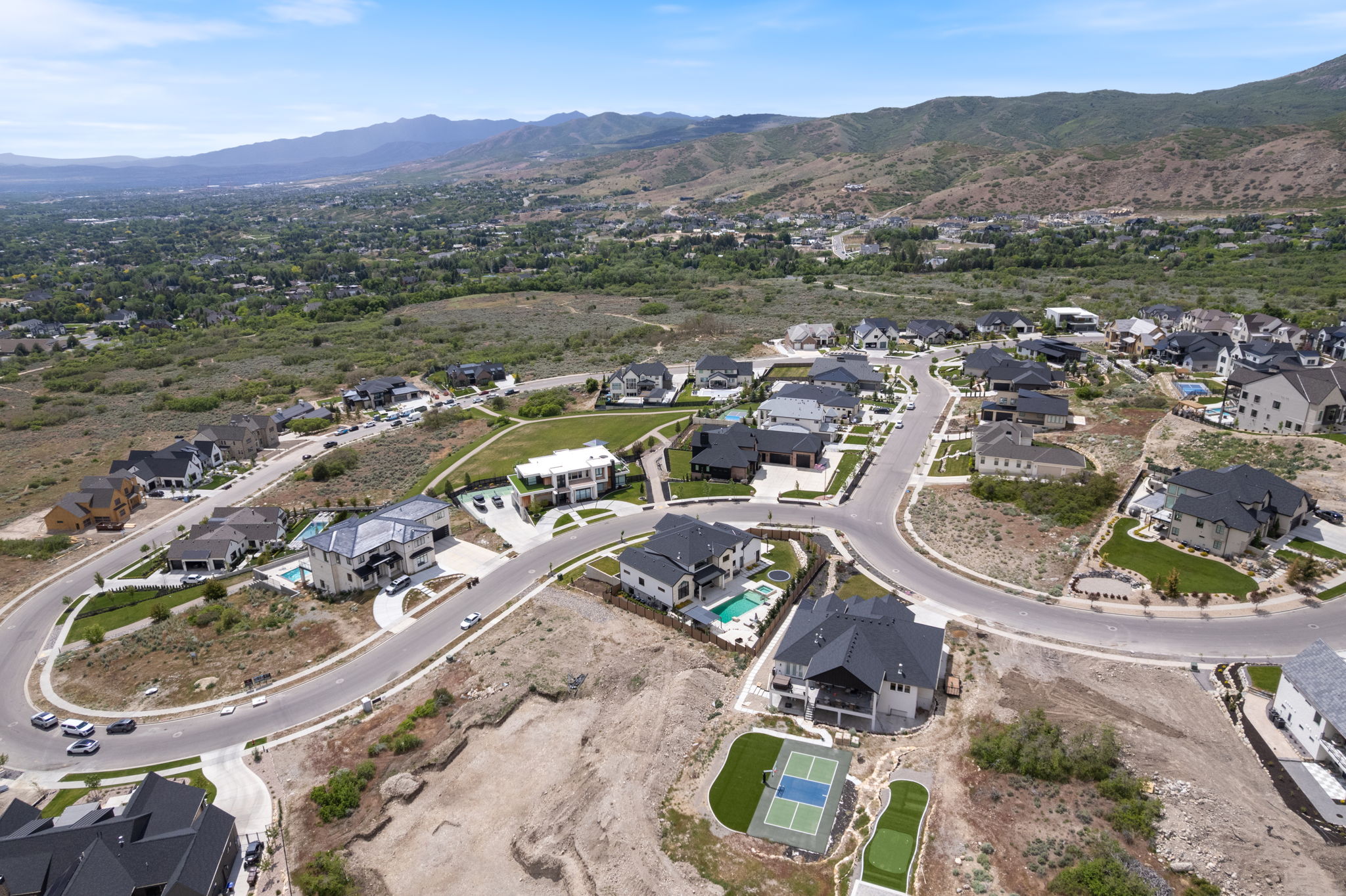 Aerial perspective showcasing a residential community with contemporary architecture and surrounding natural landscapes