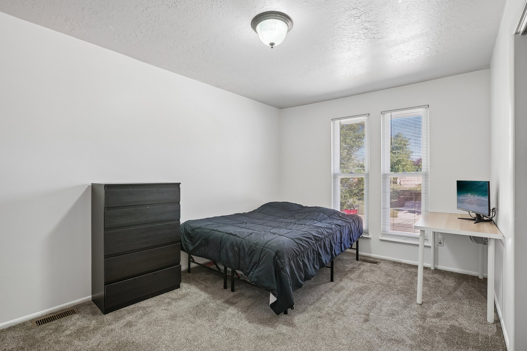 Bedroom featuring light gray carpeting and white painted walls