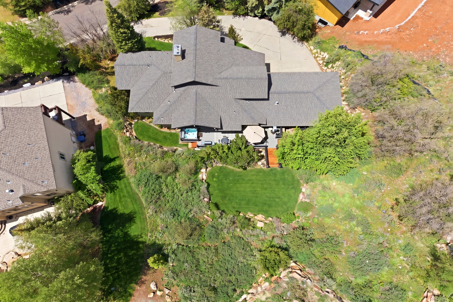 Expansive property featuring a multi-level roofline, extensive decking, and a built-in hot tub