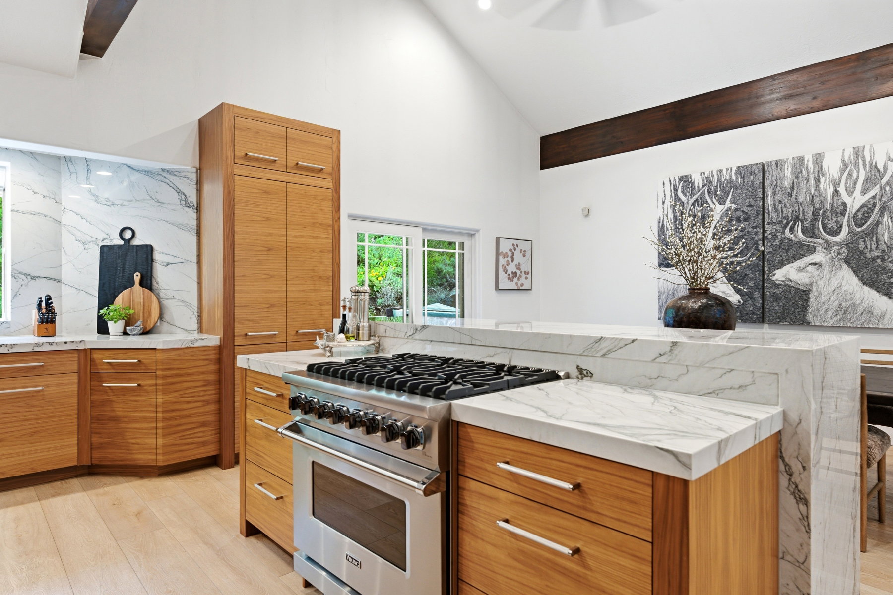 Modern kitchen featuring wood-finish cabinetry and light-toned wood-finish flooring