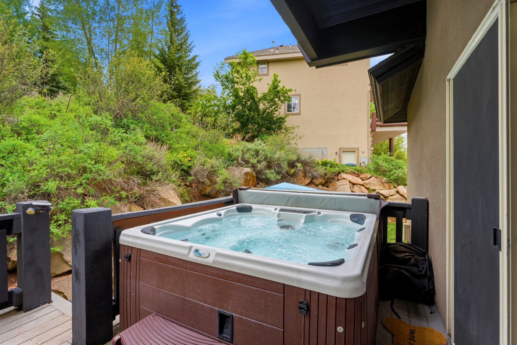 Outdoor spa with a wood-finish exterior on a multi-level deck
