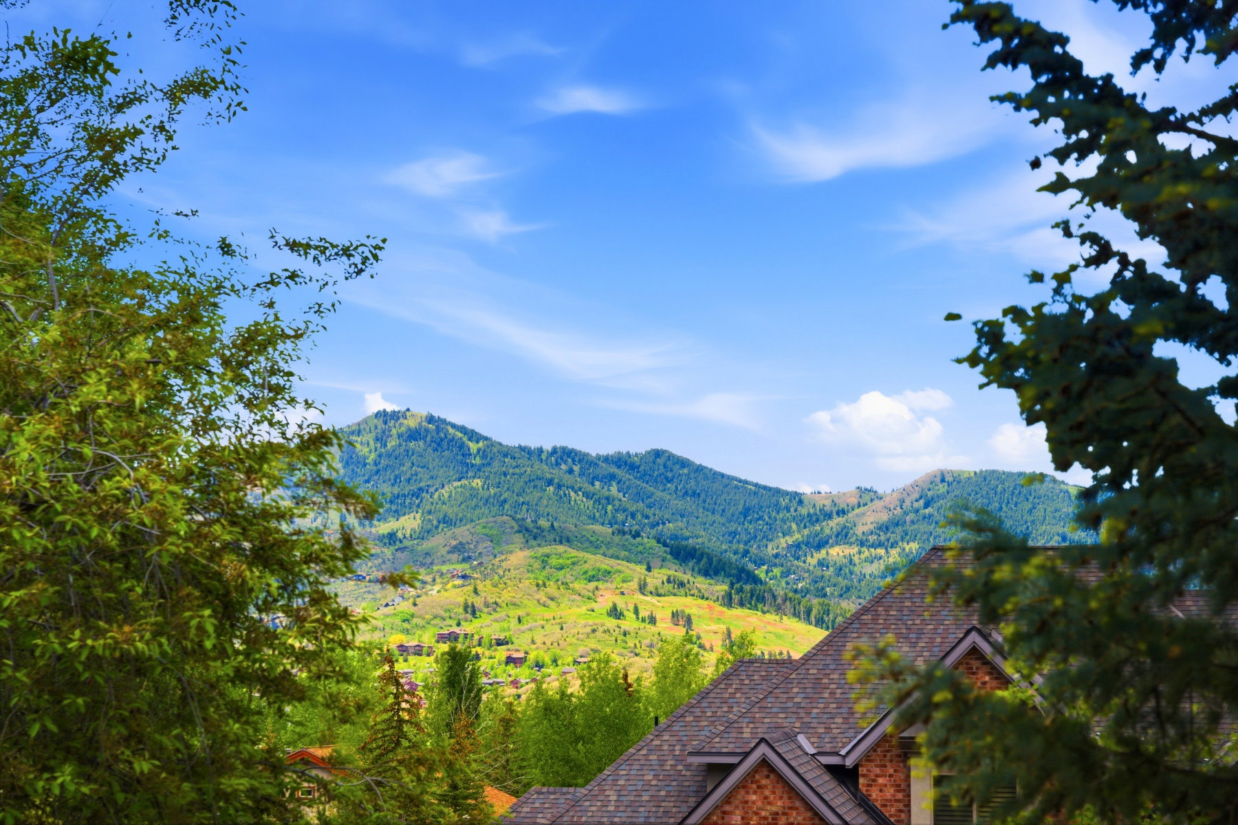 Expansive mountain scenery with residential rooftops