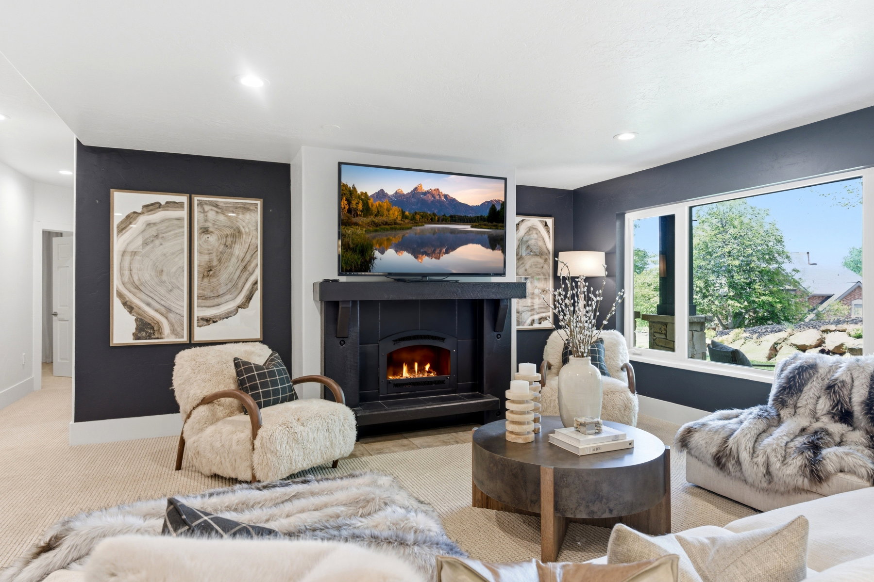 Living area featuring a black mantel fireplace with an insert, large picture windows, and recessed lighting
