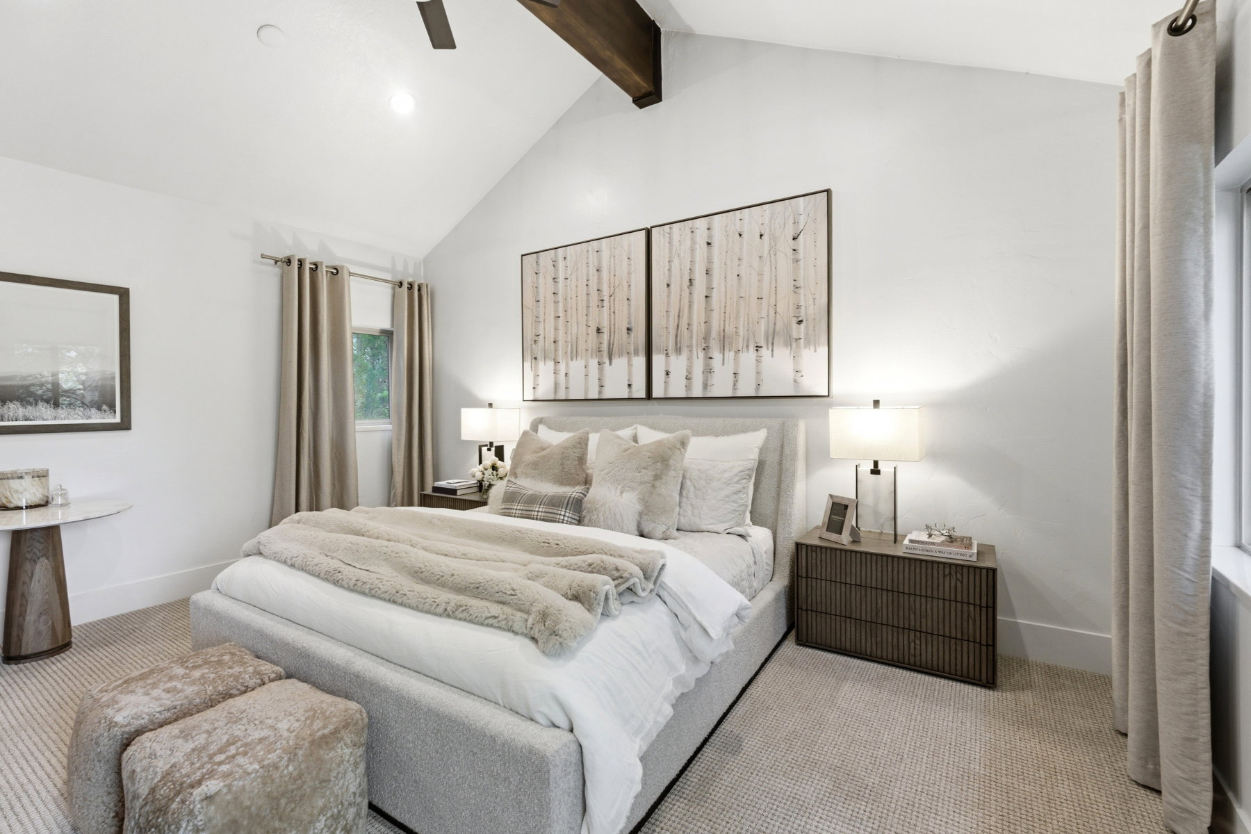 Vaulted ceiling featuring a wood beam accent and ceiling fan