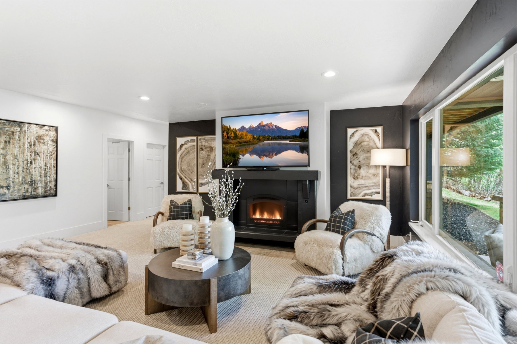 Living space featuring a built-in fireplace, recessed lighting, and large windows