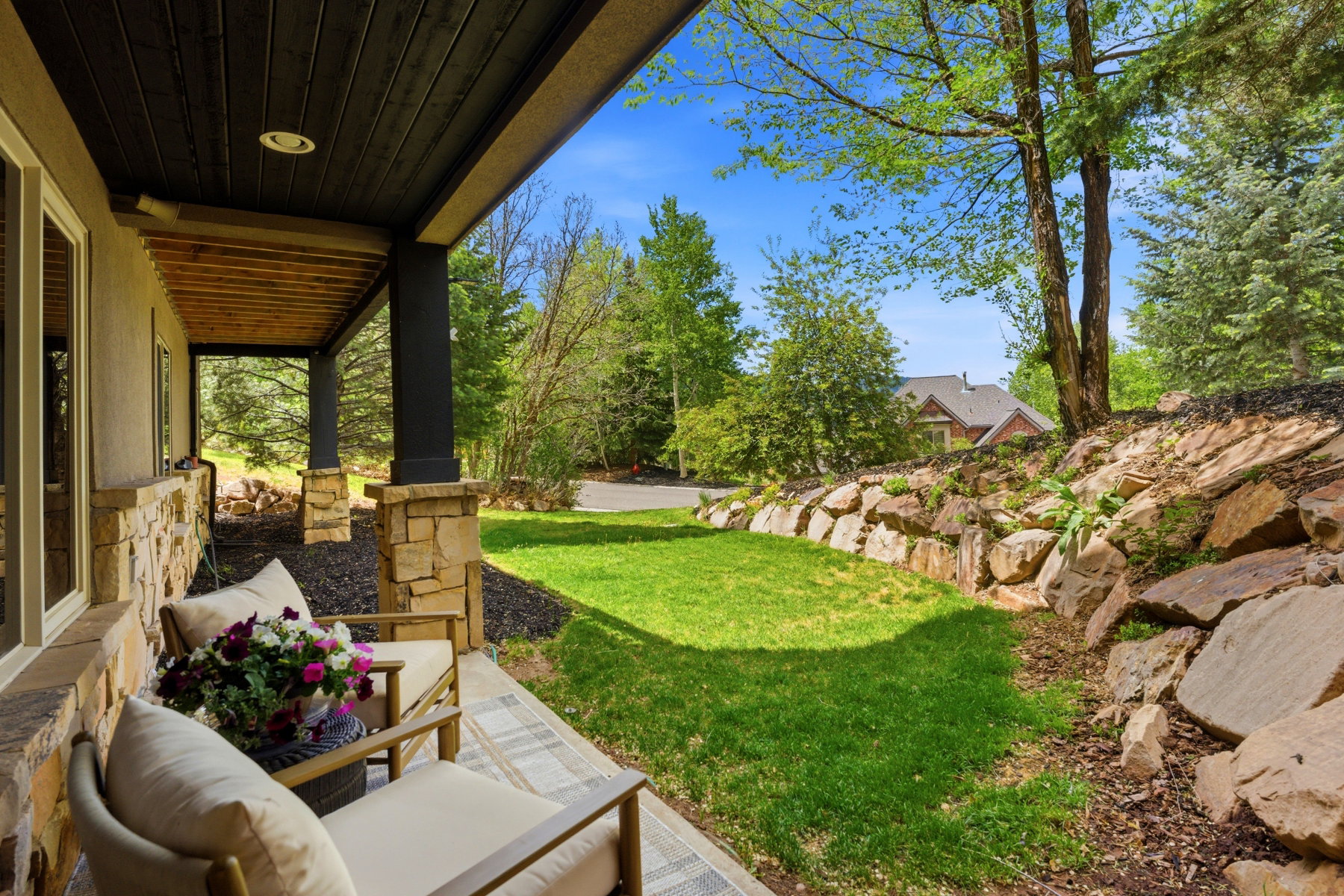 Covered outdoor patio with a plank wood ceiling and recessed lighting